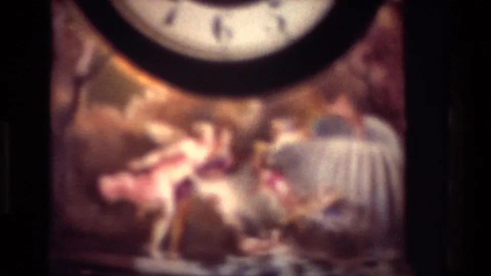 Soft 1981 New Zealand close-up of painted decorative artwork below the round face of an ornate wooden clock.
