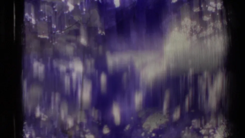 End frame from 1981 New Zealand 8mm footage showing vertical motion blur and blue-purple smearing as the film appears stuck or dragged.