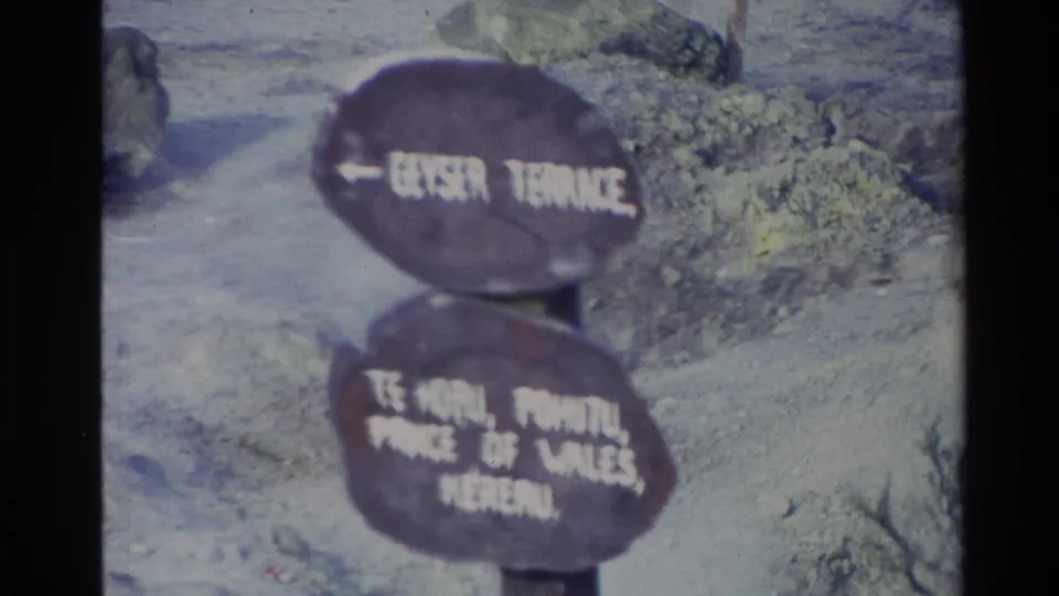 1981 New Zealand 8mm frame with a sign reading Geyser Terrace and listing Te Hōru, Pōhutu, Prince of Wales, and Mereau or similar names.