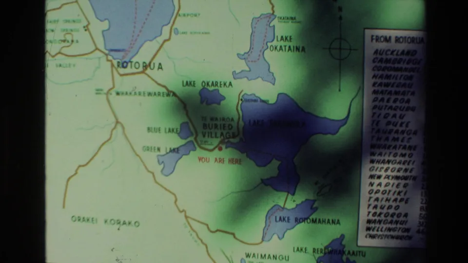 1981 New Zealand home-movie frame showing a closer view of the Rotorua-area tourist map and nearby lake labels.