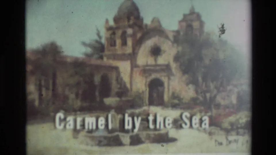 1982 8mm frame showing a soft illustrated mission-style building and the title text Carmel by the Sea.