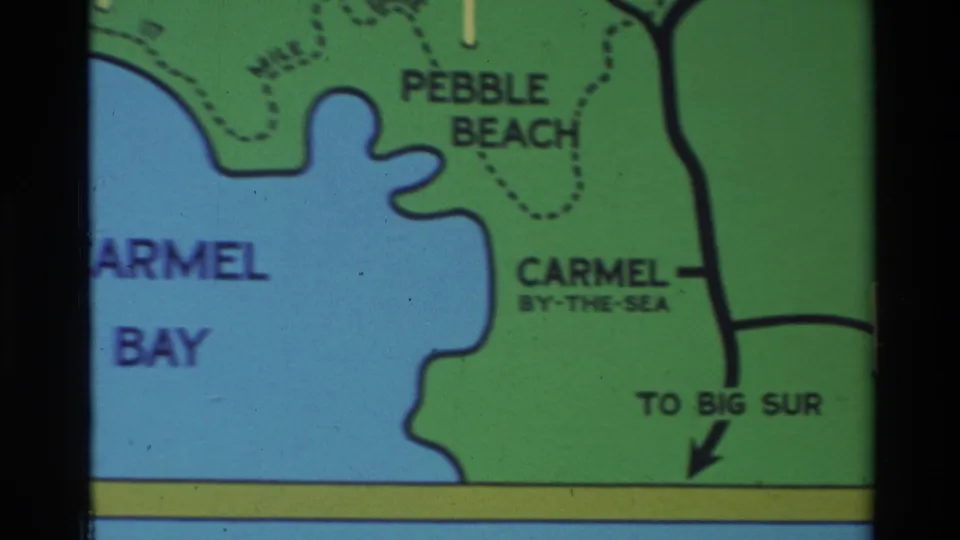 1982 Carmel-area travel map detail with blue bay, green land, Pebble Beach, Carmel-by-the-Sea, and a Big Sur direction arrow.
