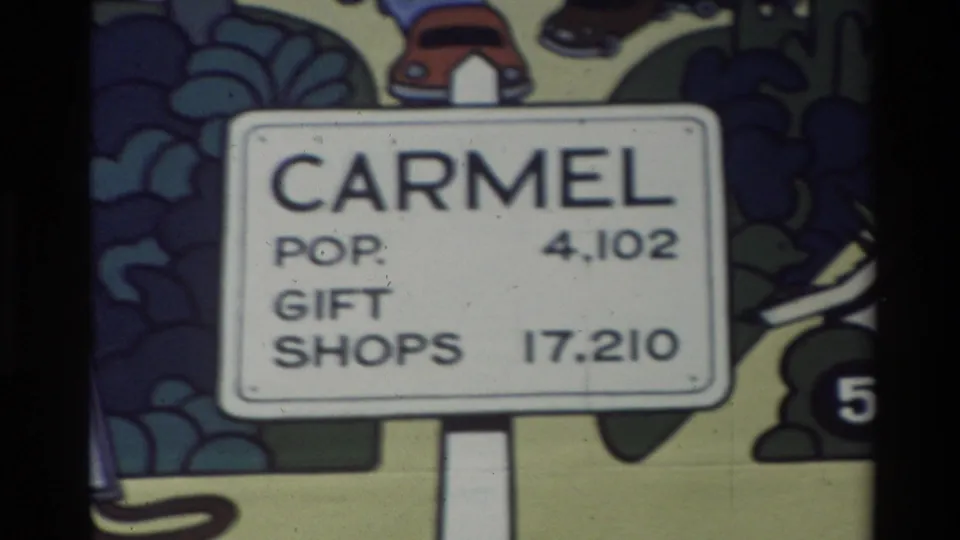 Close-up from the Carmel map area showing a sign with population 4,102 and gift shops 17,210 against colorful illustrated background graphics.