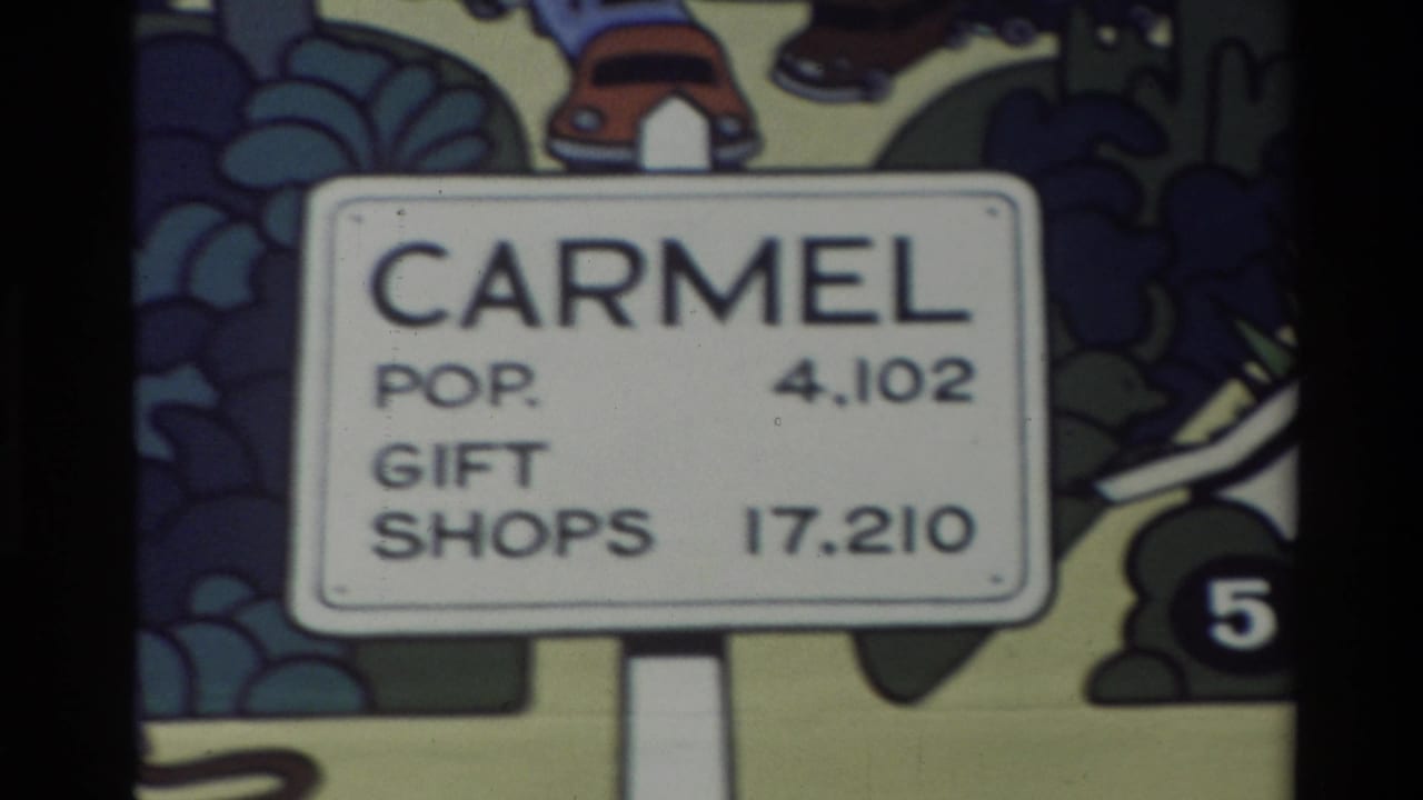 Second view of the cartoon Carmel sign with the same population and gift-shop text.