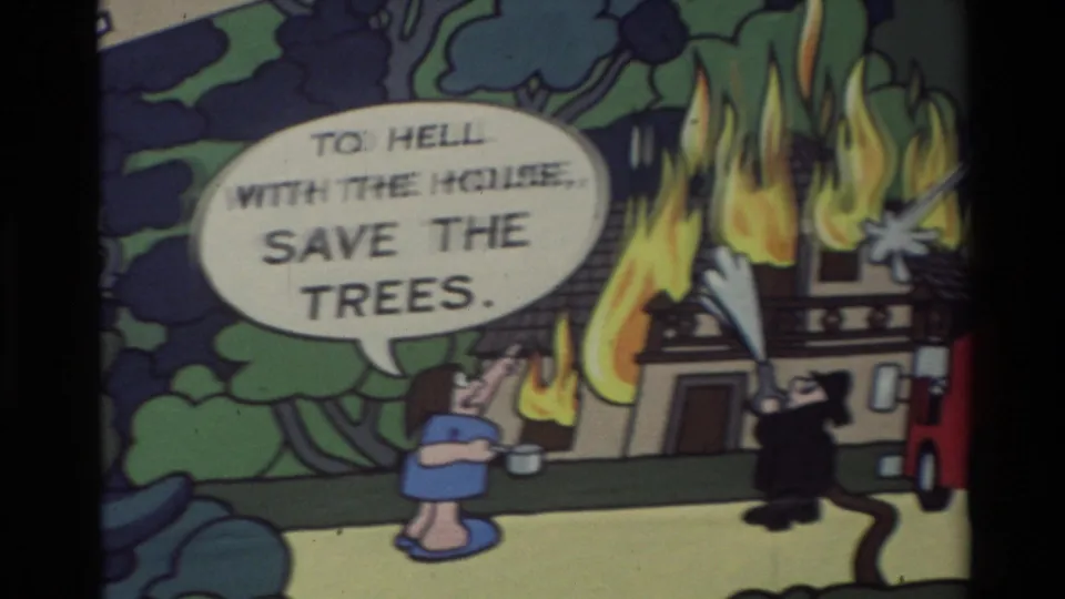 1982 8mm cartoon frame with a burning house, trees, a firefighter, and a woman beside a speech balloon about saving the trees.