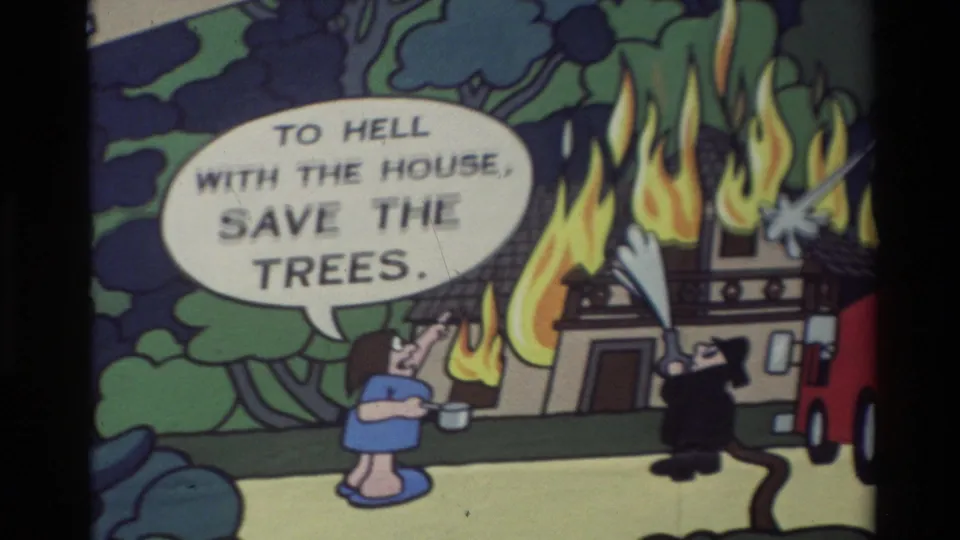 Carmel 1982 8mm frame of a cartoon house fire with a firefighter and woman under the "save the trees" speech balloon.