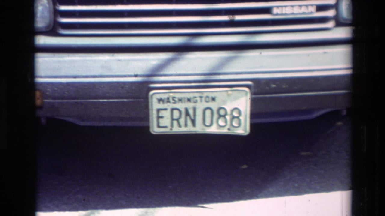 1982 Carmel frame showing a Washington plate mounted beneath the front grille of a Nissan vehicle.