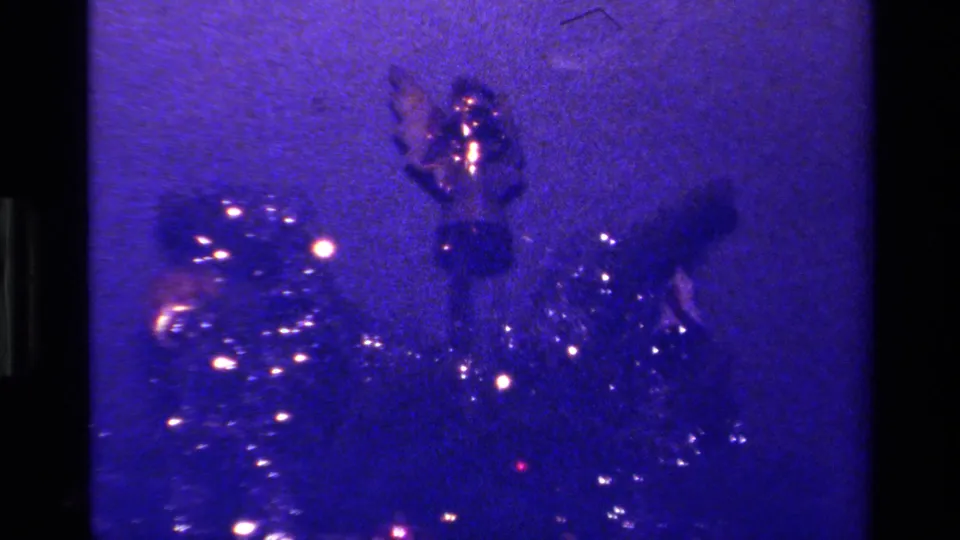 The upper part of the decorated Christmas tree is visible through blue-purple 8mm color shift in this 1979 California home footage.