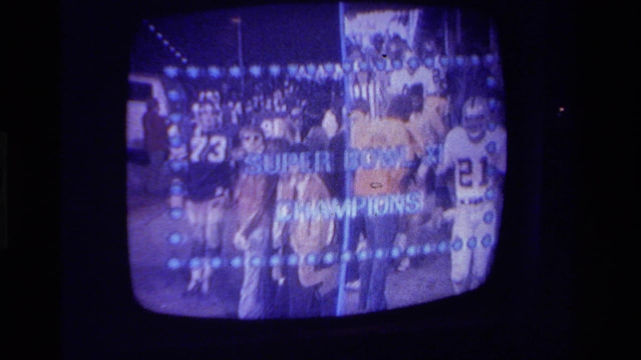 1979 California home-movie frame of a CRT television showing football players with Super Bowl XI Champions lettering.