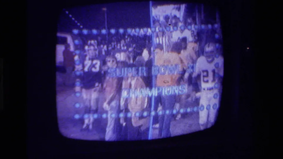 1979 California home-movie frame of a CRT television showing football players with Super Bowl XI Champions lettering.