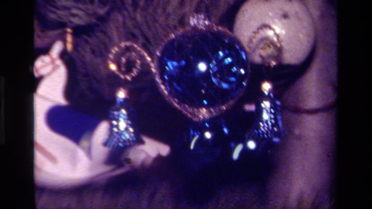 1979 California 8mm view of blue Christmas ornaments and a white rocking horse on a decorated tree.