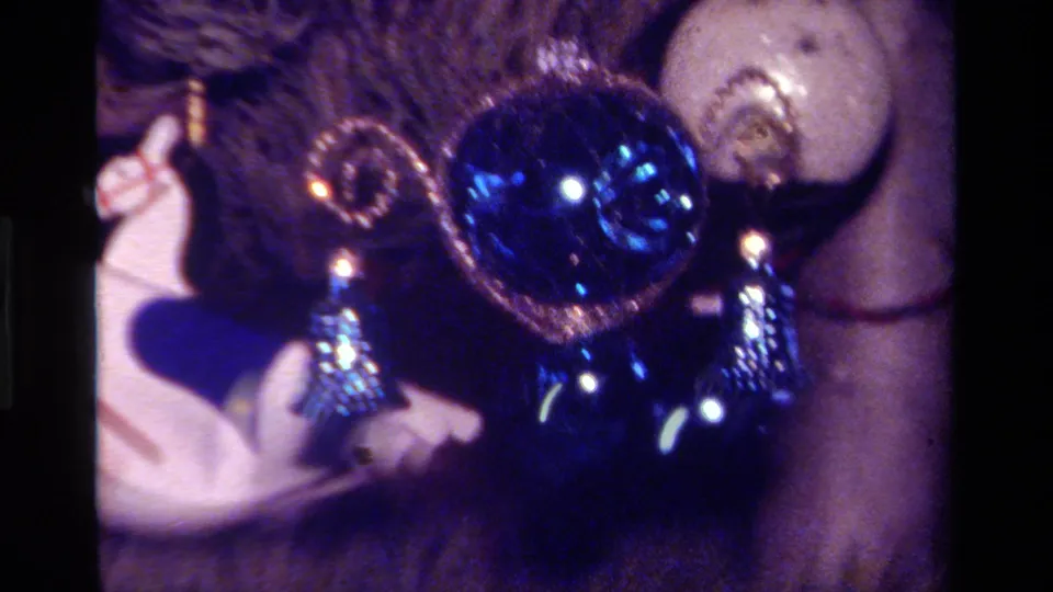 1979 California 8mm view of blue Christmas ornaments and a white rocking horse on a decorated tree.