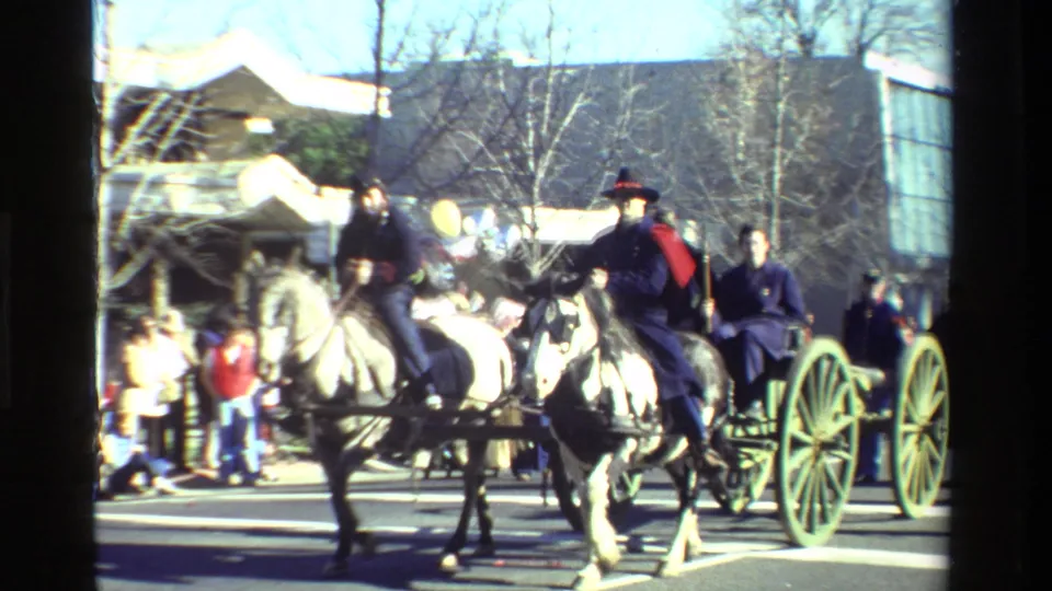 Union-style reenactors on horses ride beside a green wagon during a 1981 California street parade.
