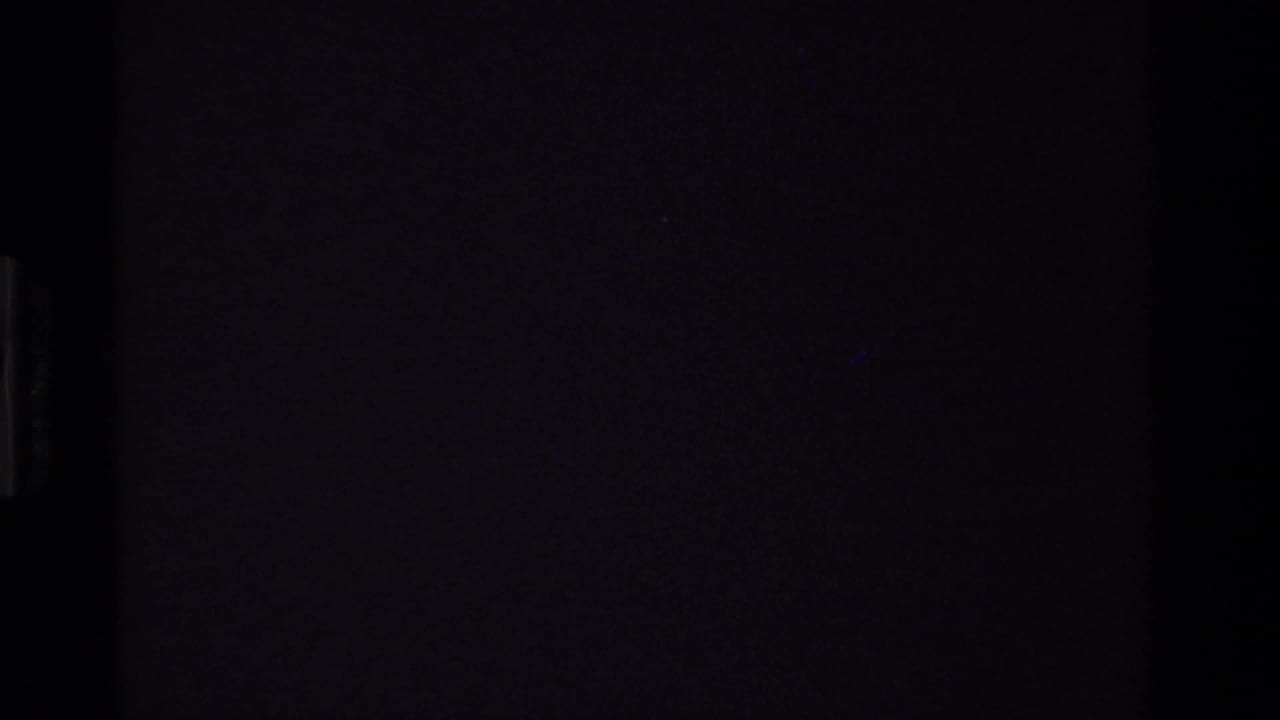 Mostly dark frame with a narrow vertical light area near the left side.