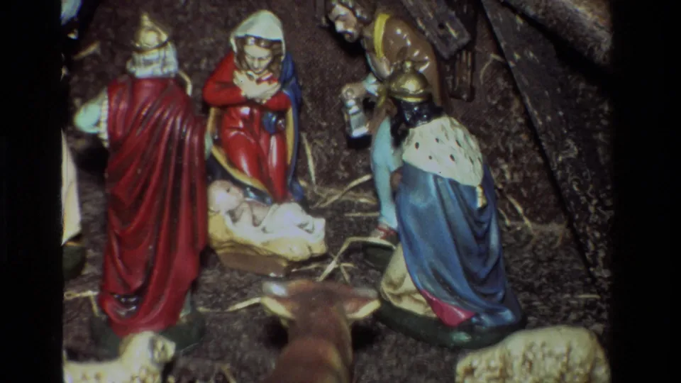 1981 California 8mm frame showing a small Christmas nativity display with wise men, straw, animals, and baby Jesus in a manger.