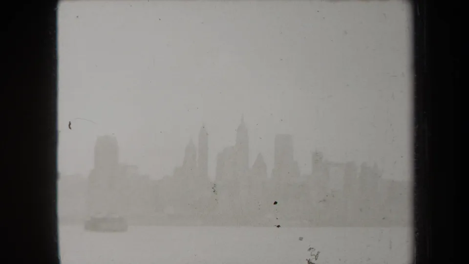 A small boat-like shape crosses the lower harbor while the foggy 1938 New York skyline remains barely visible in the background.