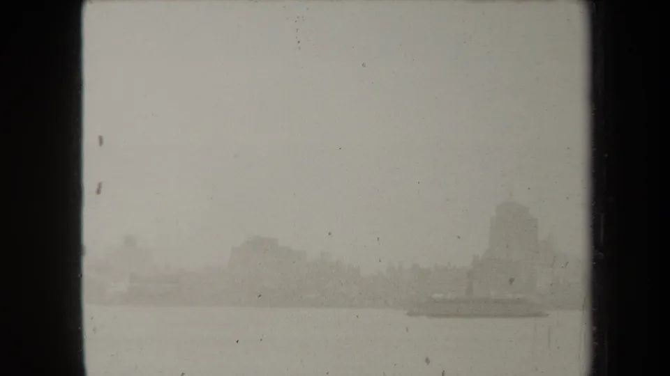 Late frame of the 1938 New York view, with fogged waterfront buildings and a low boat-like form near the right side.