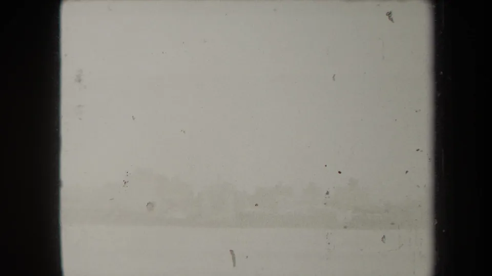Soft-focus 1938 New York waterfront view with distant structures barely visible through haze.