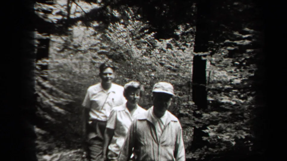 Three members of the group move toward the camera on a forest path, with 1938 New York supplied by the clip metadata.