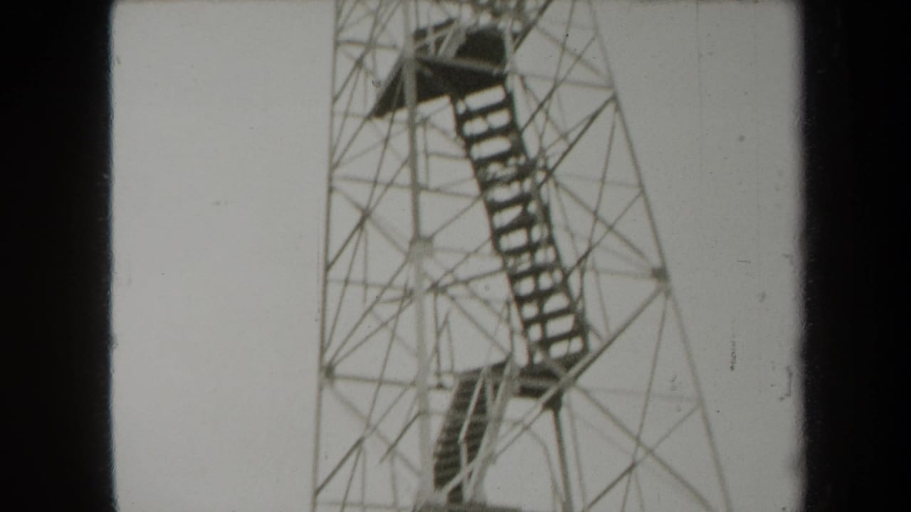1938 New York 8mm frame showing the upper portion of a metal observation tower with platforms and stair flights.