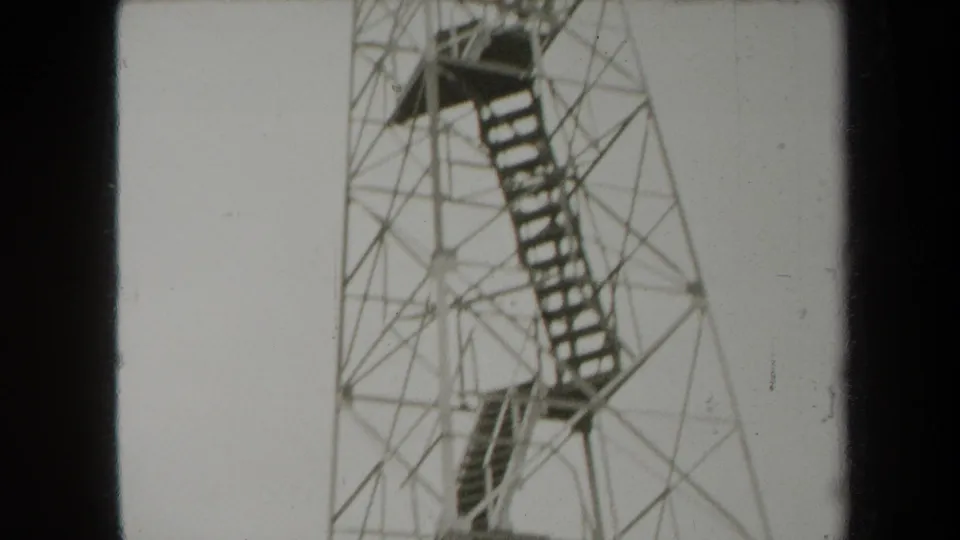 1938 New York 8mm frame showing the upper portion of a metal observation tower with platforms and stair flights.