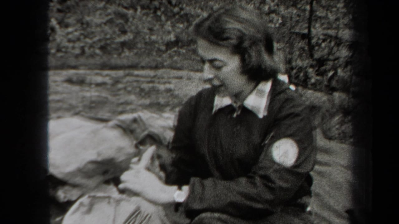 In 1938 New York home-movie footage, a woman sits on a blanket in the woods and appears to prepare food with a fork.