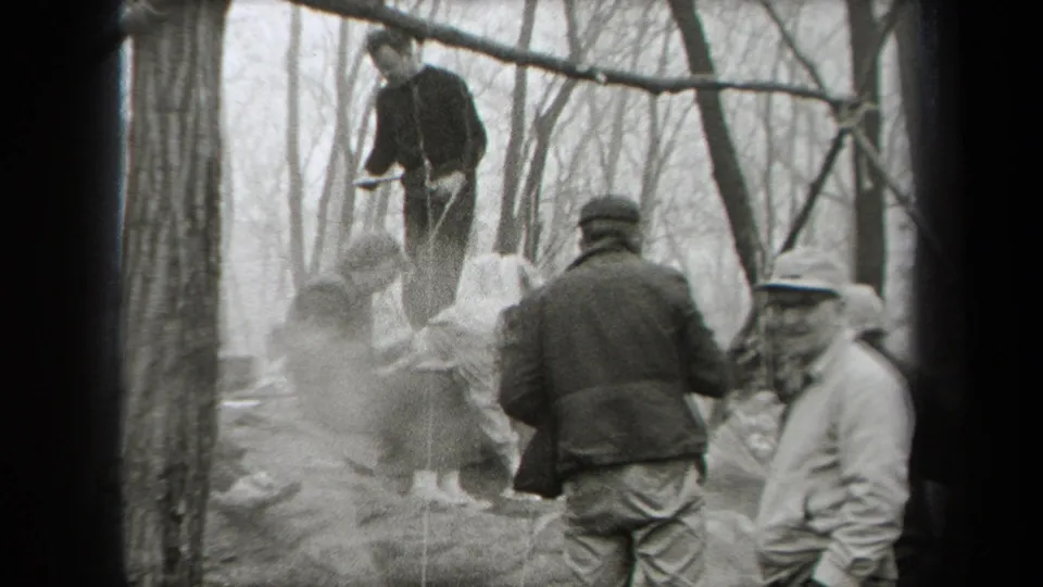 In a wooded 1938 New York scene, adults stand near rocks, smoke or steam, and outdoor cooking activity.