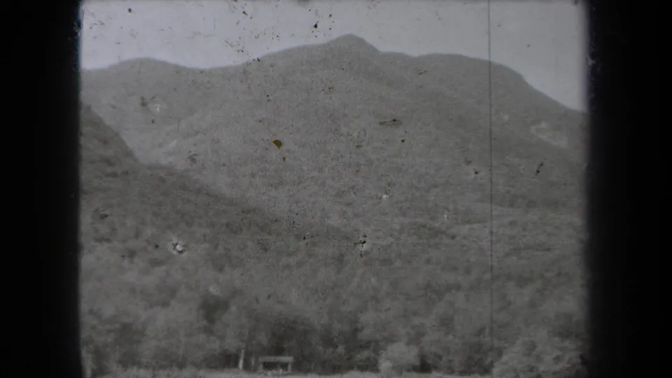 Wide 1938 New York mountain view with forested slopes and a small structure visible near the lower frame.