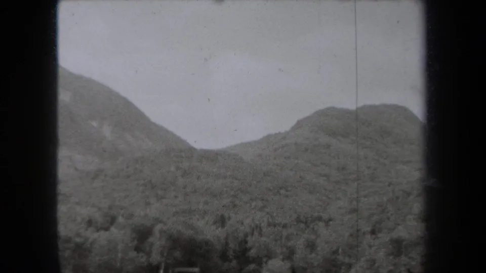 Black-and-white 1938 New York home-movie view of rounded wooded hills and a mountain valley.