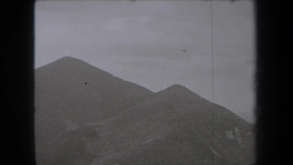 1938 New York mountain vista with overlapping ridgelines, pale cloud cover, and visible black film borders from the 8mm scan.