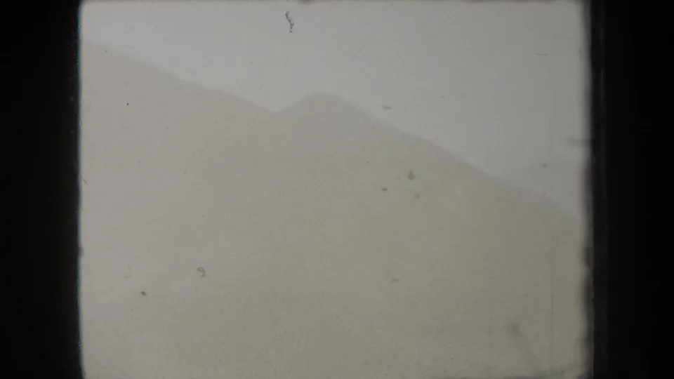 The final frame holds on a subdued 1938 New York mountain view, where fog softens the ridge and the 8mm gate edge remains visible.