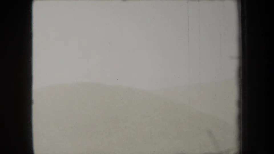 1938 New York 8mm home-movie frame with a low, misty hillside and soft exposure across the film gate.