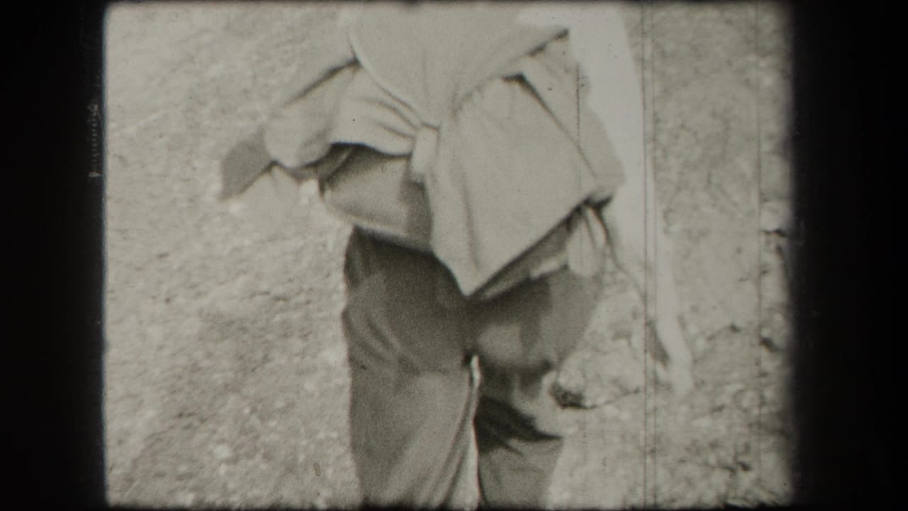 Close rear view of a woman carrying a large bundle while walking outdoors.