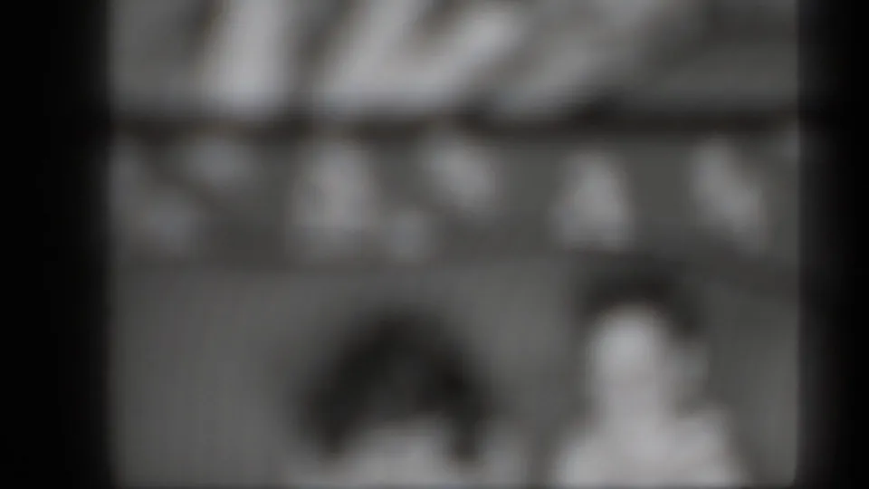 Metadata-supported 1939 New York 8mm frame showing two indistinct people in a heavily unfocused view.