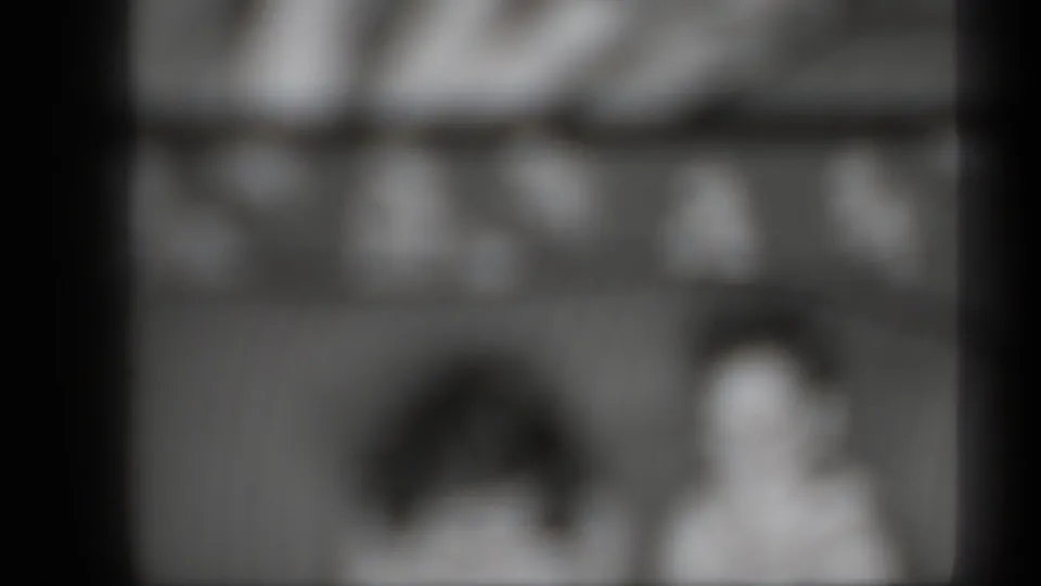 1939 New York 8mm home-movie frame with two soft human silhouettes and visible film-panel boundaries.