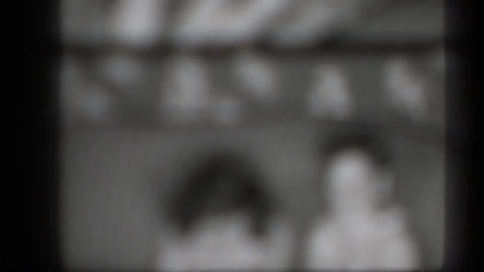 1939 New York 8mm frame showing two blurred people, dark gate edges and soft grayscale film texture.