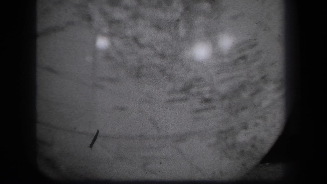 Close 1939 New York 8mm view of the globe surface, with map texture partly obscured by blur, dust, and reflected light.