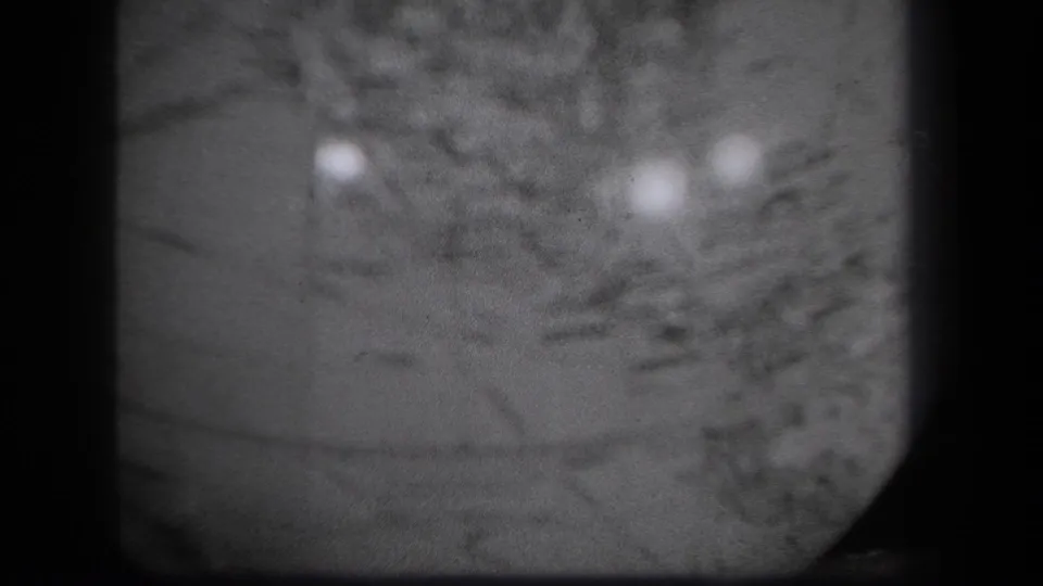 Black-and-white 8mm frame from 1939 New York showing a softly focused globe close-up with rounded edge and reflected light.