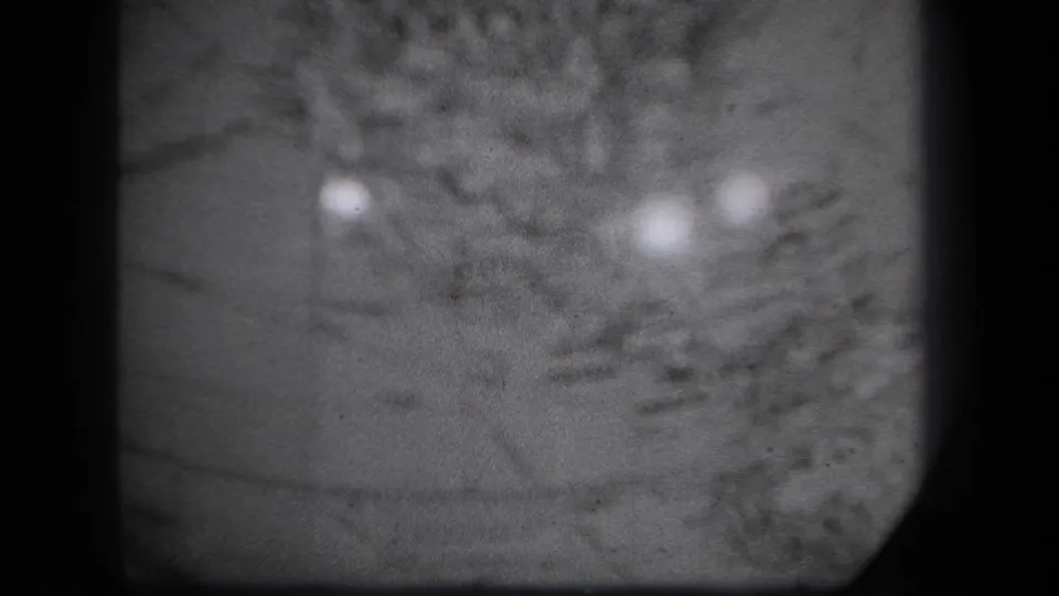 Final sampled 1939 New York 8mm frame showing the globe in close-up, with faint cartographic markings and bright reflections.