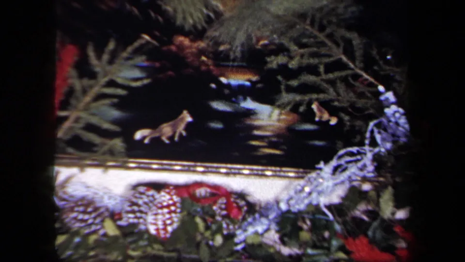 1958 New York home-movie close-up of animal figurines set into Christmas mantel greenery and silver tinsel.