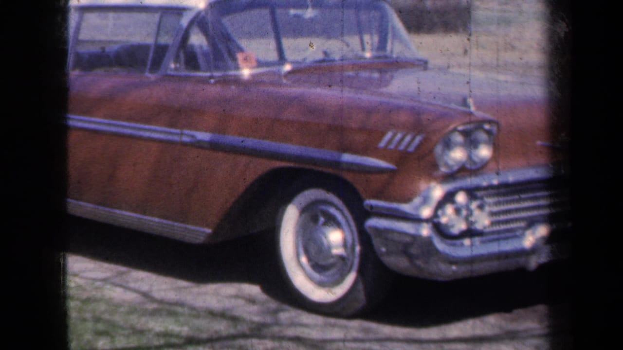 Brown Chevrolet Bel Air convertible parked by a rural road in 1959 New York home-movie footage.