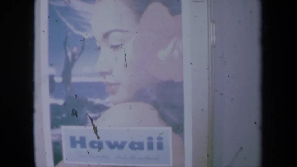 1961 California 8mm close view of the Hawaii poster, showing the woman's profile and large Hawaii lettering near the bottom.