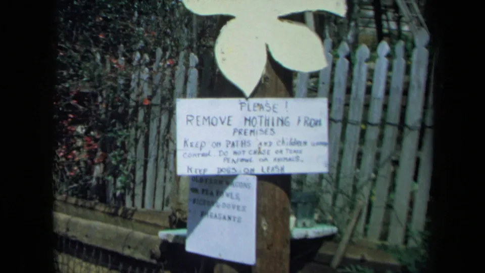 1969 California 8mm frame with a closer view of the hand-painted premises sign and visitor instructions.