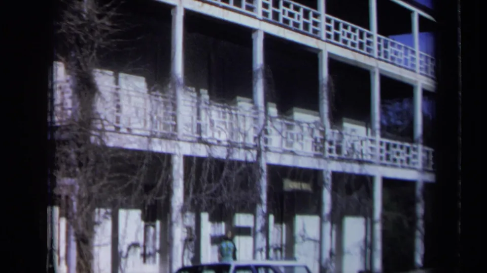 Wider 1969 California view of the St. George Hotel facade with balconies, windows, vines, and the hotel sign near street level.