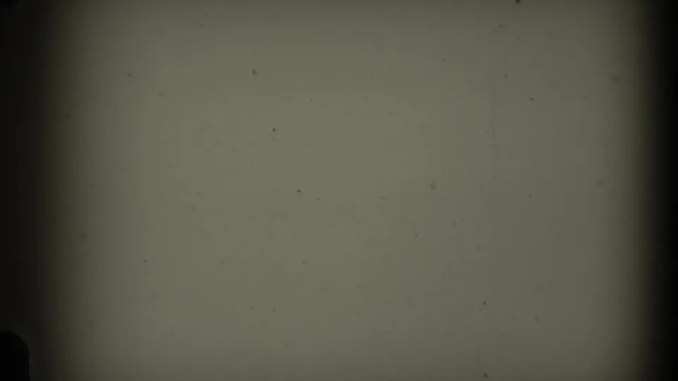 1969 California 8mm frame showing pale aged film, scattered specks, dark vignetting, and rounded gate-edge shapes.