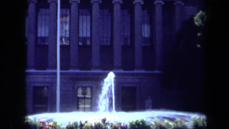 Closer 1969 California 8mm view of the fountain, flagpole, windows, and lower portion of the columned facade.