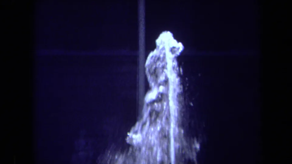 Close 1969 California 8mm view of the fountain's water plume, with bright spray breaking around the top of the spout.