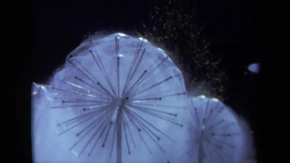 1969 Sacramento 8mm frame showing the modernist fountain’s radial structure and water spray in cool nighttime light.