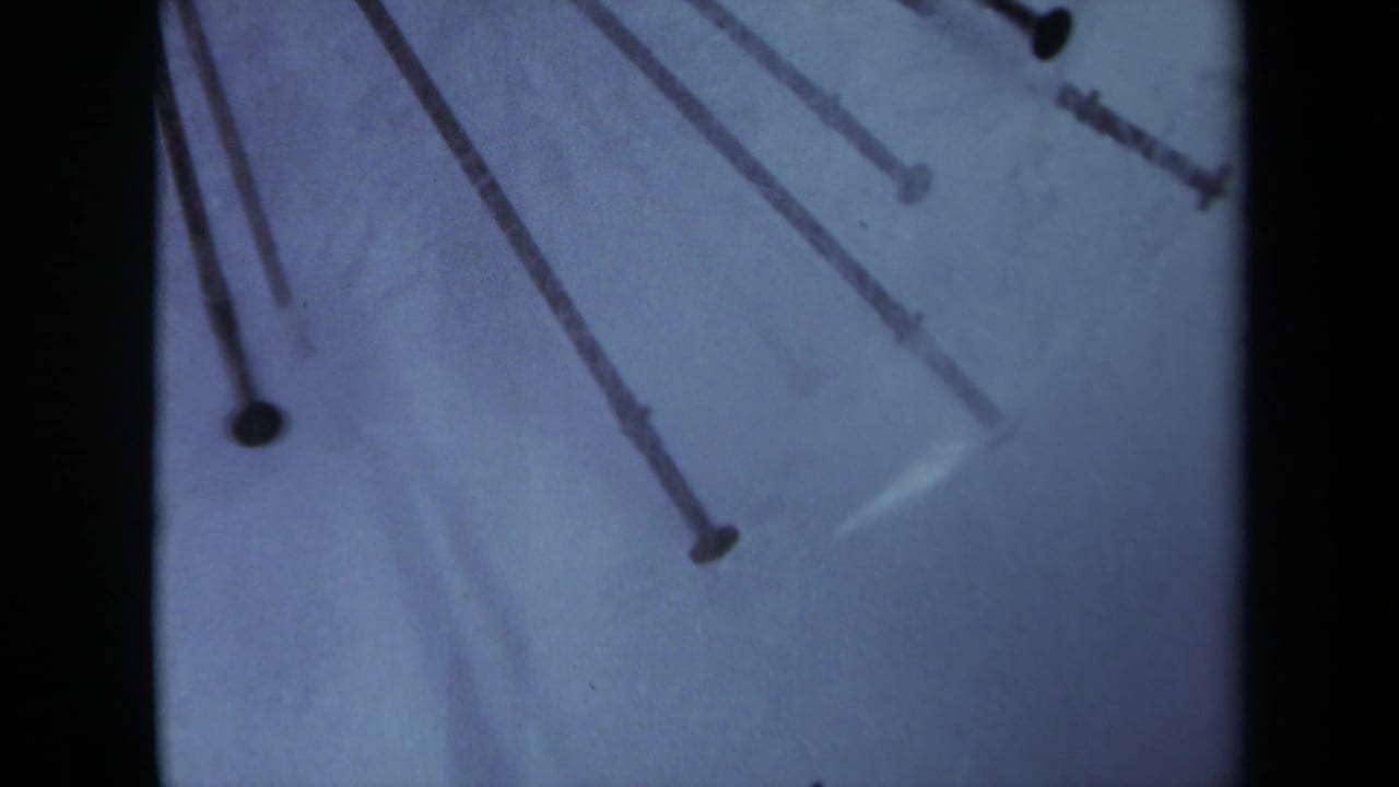 Radial nail ends extend from the upper edge over a pale blue background.