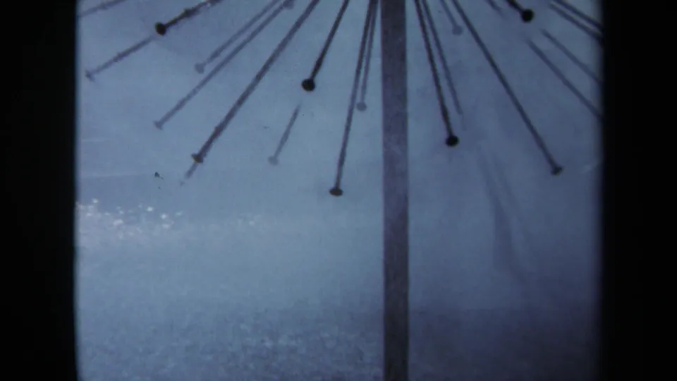 Wider 1969 Sacramento 8mm frame showing the nail arrangement as a sunburst form around a vertical pole.